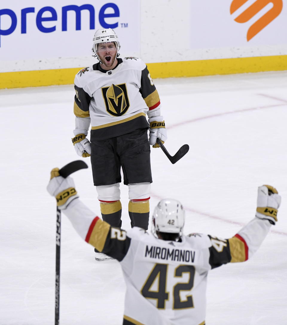 Vegas Golden Knights' Jonathan Marchessault (81) celebrates his goal against the Winnipeg Jets with Daniil Miromanov (42) during the third period of an NHL Hockey game in Winnipeg, Manitoba on Tuesday, Dec. 13, 2022. (Fred Greenslade/The Canadian Press via AP)