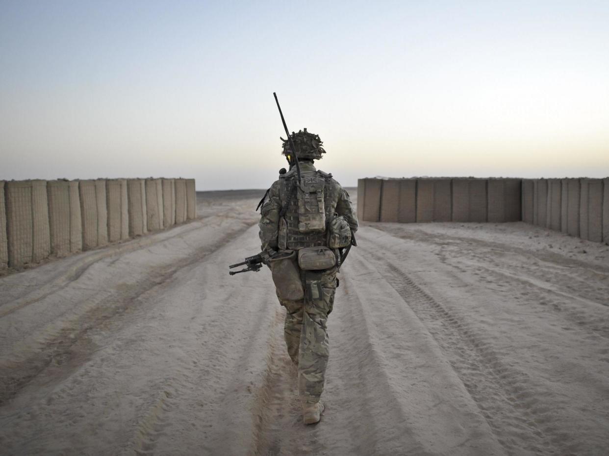 A soldier from the 1st Battalion Royal Regiment Fusiliers leaves the security of the camp walls to conduct a dawn foot patrol in the Nahr-e Saraj district, Helmand Province, Afghanistan: PA