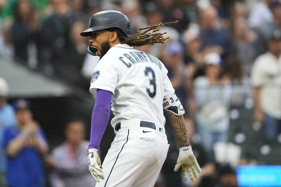 Seattle Mariners' J.P. Crawford yells as he crosses home plate after hitting a solo home run against the Oakland Athletics during the first inning of a baseball game Monday, Aug. 28, 2023, in Seattle. (AP Photo/Lindsey Wasson)