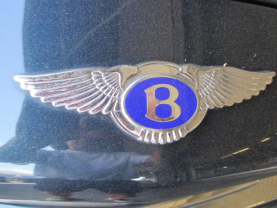 The wings adorning a Bentley badge reflects the company's origins as an aircraft engine manufacturer.