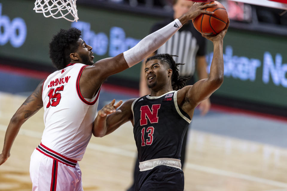 Rutgers center Myles Johnson (15) blocks a shot by Nebraska forward Derrick Walker (13) in the first half during an NCAA college basketball game Monday, March 1, 2021, in Lincoln, Neb. (AP Photo/John Peterson)