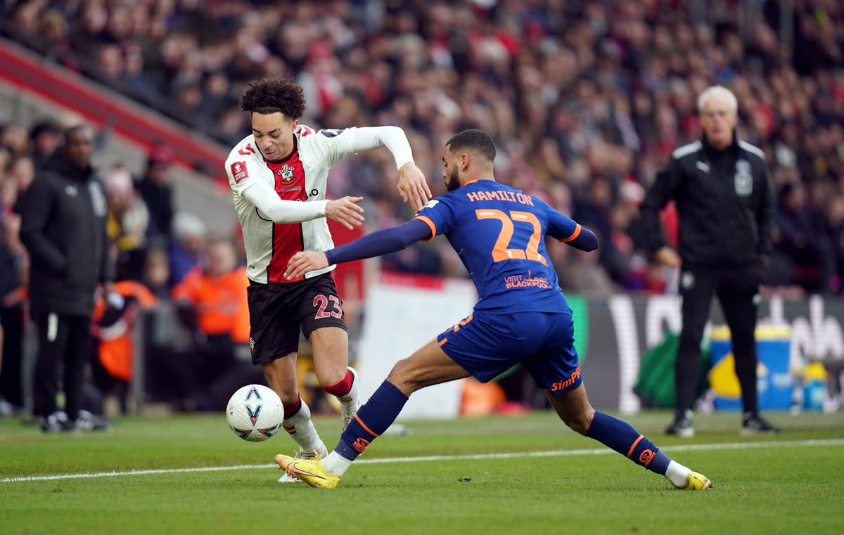 Southampton's Samuel Edozie and Blackpool's CJ Hamilton battle for the ball (PA)