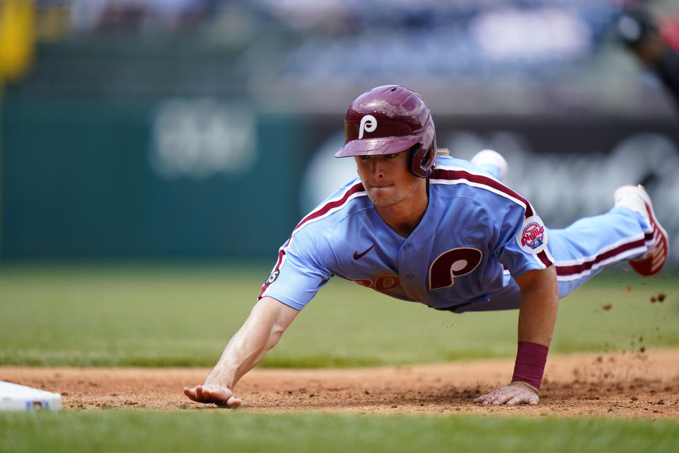 Philadelphia Phillies' Luke Williams dives back to first base on a pickoff attempt during the second inning of a baseball game against the Atlanta Braves, Thursday, June 10, 2021, in Philadelphia. (AP Photo/Matt Slocum)