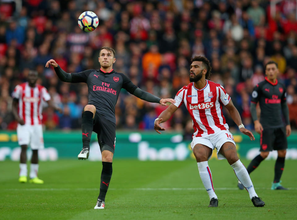 Aaron Ramsey of Arsenal clears the ball while under pressure from Maxim Choupo-Moting of Stoke City during the Premier League match between Stoke City and Arsenal at Bet365 Stadium