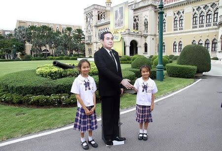 Children pose next to a cardboard cut-out of Thailand's Prime Minster Prayuth Chan-ocha at the government house in Bangkok, Thailand January 8, 2018. Picture taken January 8, 2018. Dailynews via REUTERS