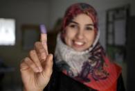 A woman shows her ink-marked finger after voting in the municipal election at a polling station in Benghazi April 19, 2014. REUTERS/Esam Omran Al-Fetori