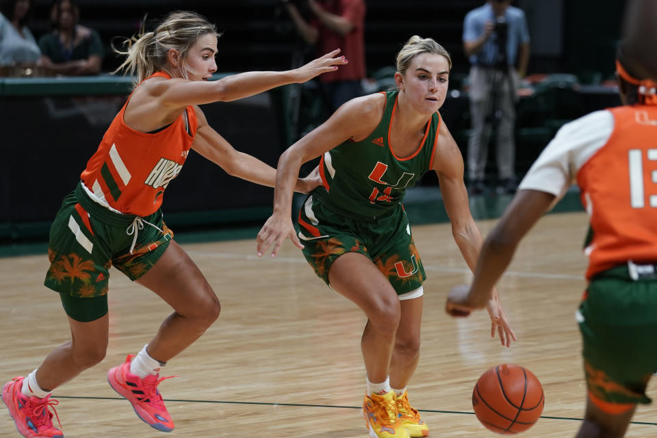 FILE - Miami NCAA college basketball guards and sisters, Haley and Hanna Cavinder, practice Friday, Oct. 7, 2022, in Coral Gables, Fla. Haley and Hanna Cavinder are going to the NCAA Tournament. The Miami guards are perhaps the faces of the NIL movement in college athletics. And they have a massive following on social media. (AP Photo/Matt Dirksen, File)