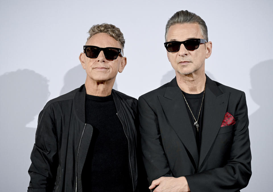 Musicians Martin Gore, left, and Dave Gahan of the British band Depeche Mode stand in front of a photo wall during a photo session in Berlin, Germany, Tuesday, Oct. 4, 2022. (Britta Pedersen/dpa via AP)