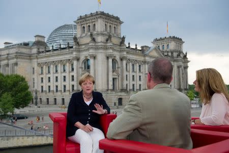 German Chancellor Angela Merkel (L) talks during ARD summer-interview with journalists Tina Hassel and Thomas Baumann in Berlin, Germany, August 28, 2016. REUTERS/Stefanie Loos