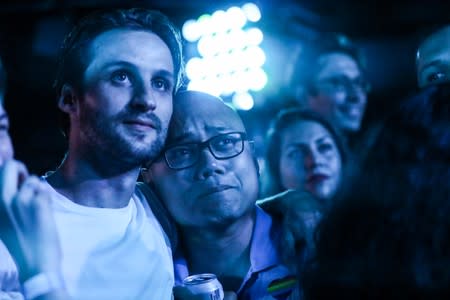 Supporters watch on screen during an election night event in the Queens borough of New York City