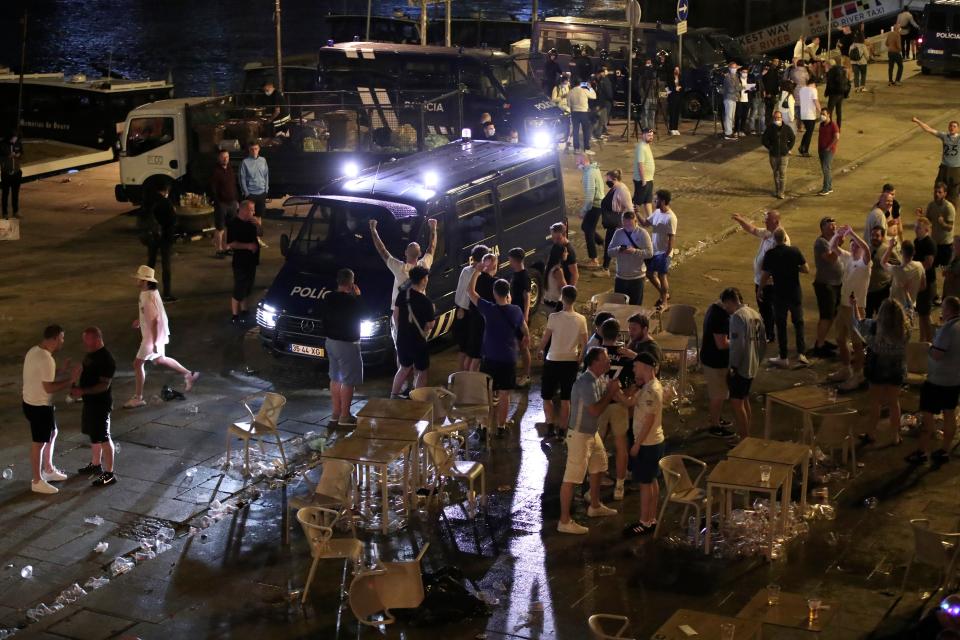 A police van tries to disperse supporters last night (AP)