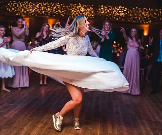 Brides are forgoing heels in favour of wedding trainers [Photo: Instagram/<a class="link " href="https://www.instagram.com/elmorecourt/" rel="nofollow noopener" target="_blank" data-ylk="slk:elmorecourt;elm:context_link;itc:0;sec:content-canvas">elmorecourt</a>]