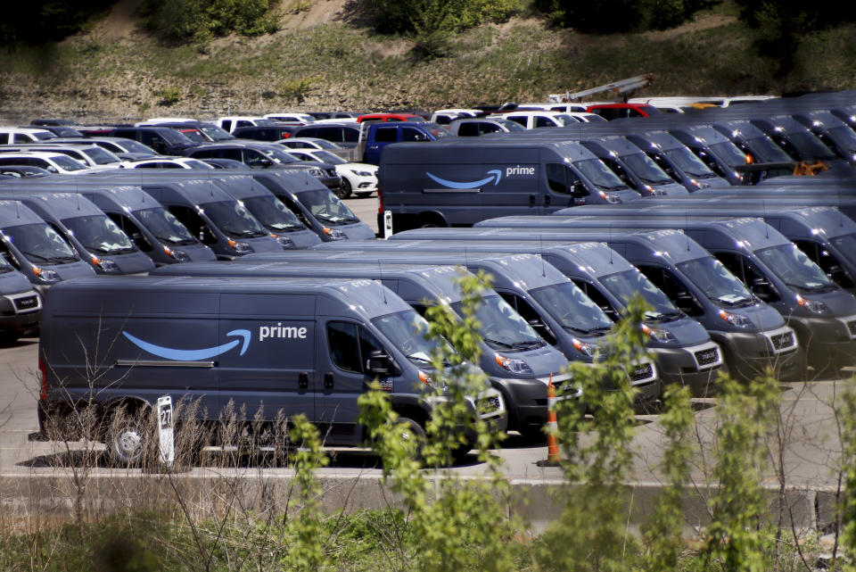 Rows of Amazon Prime delivery vans are stored in the lots at the Cox Automotive Inc. Manheim Pittsburgh vehicle auctioning location in Cranberry Township, Pa., Wednesday, May 13, 2020. The corporation announced earlier this week it will furlough hundreds of workers here and more at it's other locations around the country due to the COVID-19 pandemic. (AP Photo/Keith Srakocic)