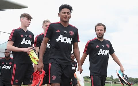 Demetri Mitchell walks out with Juan Mata of Man Utd - Credit: Getty Images