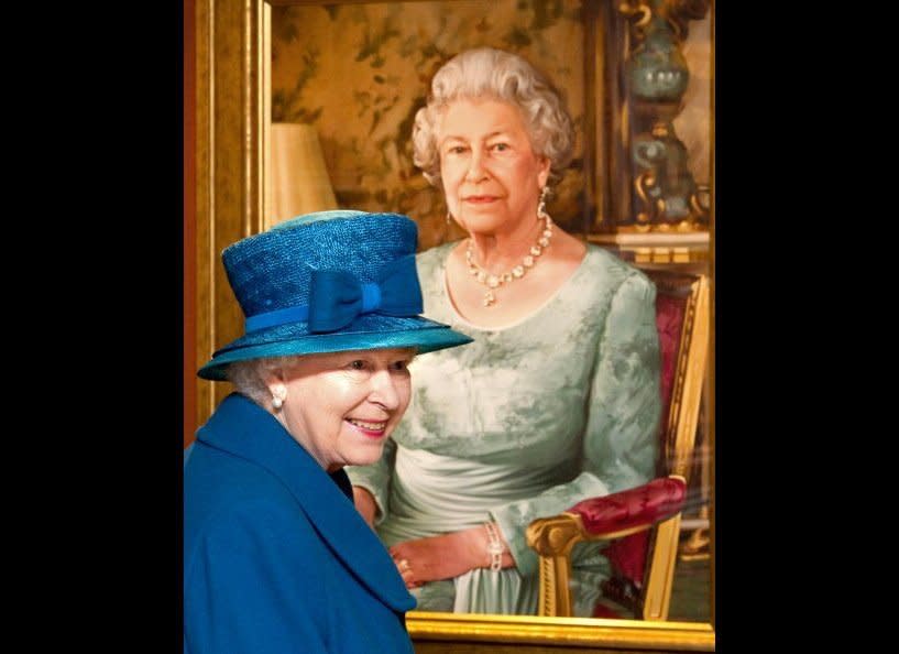 Britain's Queen Elizabeth reacts after viewing a specially commissioned portrait of herself in 'The Queen's Room' during her tour of Cunard's new cruise ship the 'Queen Elizabeth' in Southampton, southern England on October 11, 2010. The ship will leave Southampton tomorrow on its maiden voyage to the Canary Islands.          <em>ARTHUR EDWARDS/AFP/Getty Images</em>
