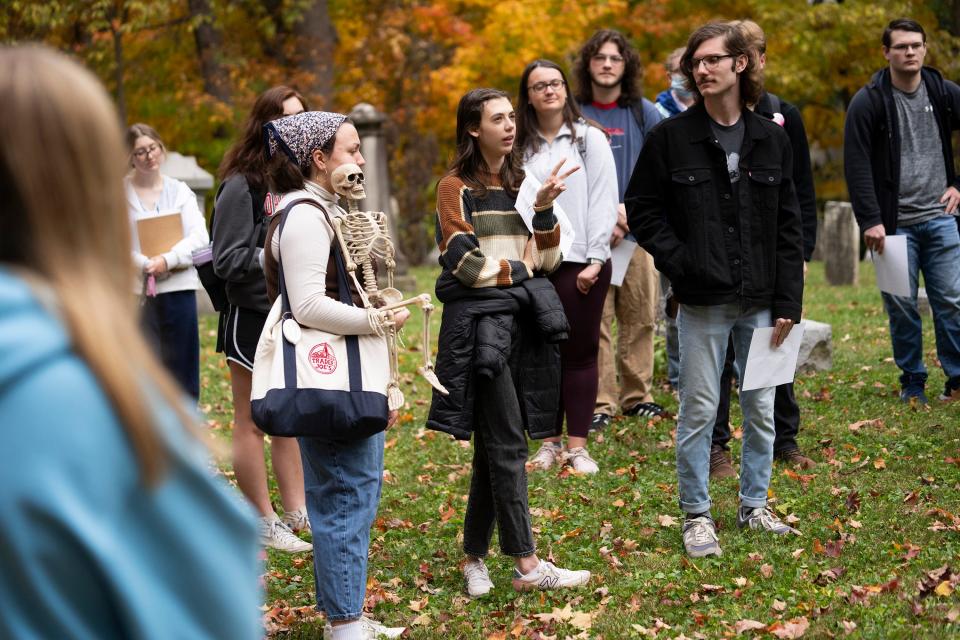 Otterbein University student Jenna Davies asks questions during a visit to the Olde Methodist Cemetery in Westerville as part of a "philosophy of death" class.