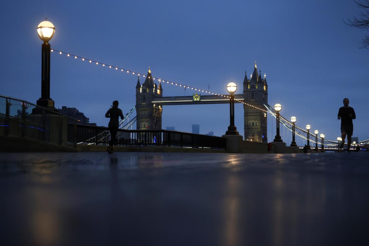 <p>A woman wears a face mask at a London Underground station</p> (REUTERS)