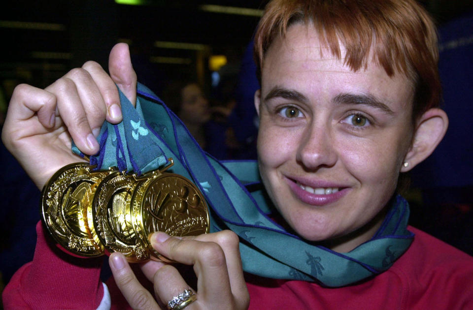 Birmingham wheelchair athlete Tanni Grey-Thompson displays her four track Gold Medals as she arrived at Heathrow Airport, from the Paralympic Games in Sydney, Australia. *The Great Britain team returned from the 11-day event with 131 medals, including 41 golds.