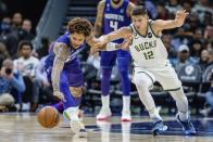 Charlotte Hornets guard Kelly Oubre Jr., left, and Milwaukee Bucks guard Grayson Allen fo after the ball during the first half of an NBA basketball game Saturday, Dec. 3, 2022, in Charlotte, N.C. (AP Photo/Scott Kinser)