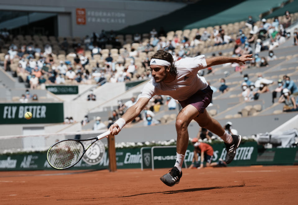 Stefanos Tsitsipas of Greece plays a return to Spain's Pablo Carreno Busta during their fourth round match on day 8, of the French Open tennis tournament at Roland Garros in Paris, France, Sunday, June 6, 2021. (AP Photo/Thibault Camus)