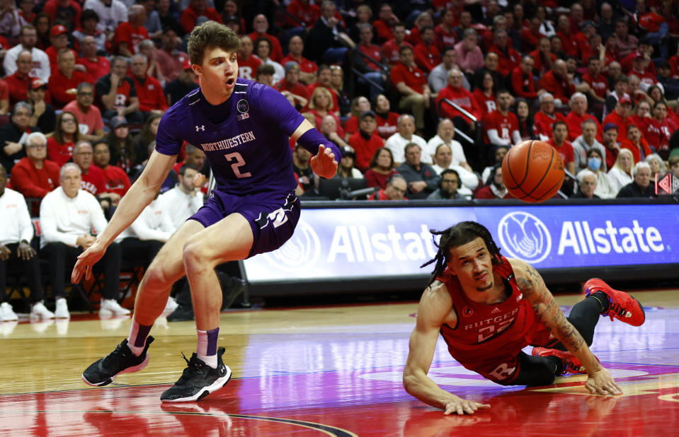 Northwestern forward Nick Martinelli (2) and Rutgers guard Caleb McConnell vie for a loose ball during the first half of an NCAA college basketball game, Sunday, Mar.5, 2023 in Piscataway, N.J. (AP Photo/Noah K. Murray)