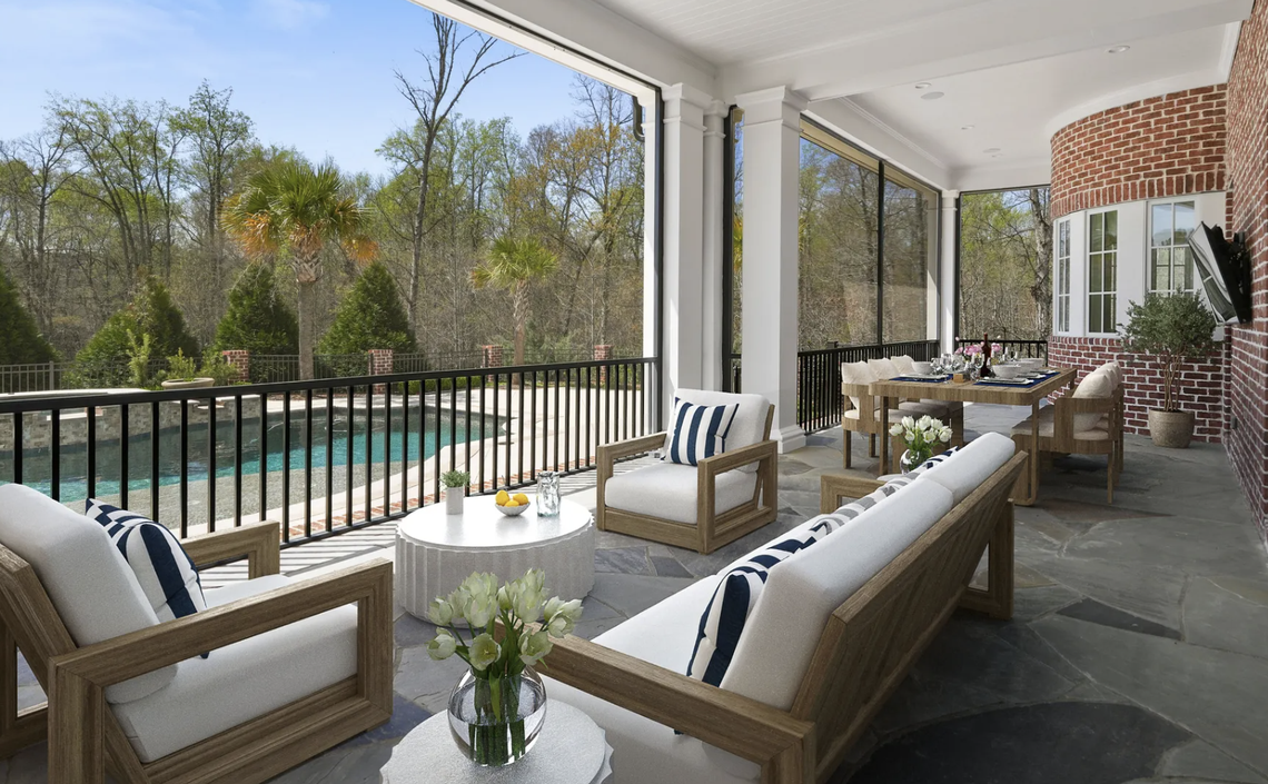 The covered patio overlooks the pool and hot tub.