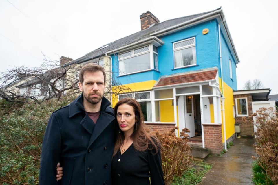 Rend Platings and her husband Michael outside their home in Cambridge, which they have painted in the colours of the Ukraine flag in a show of support for friends in the country. (Joe Giddens/ PA) (PA Wire)