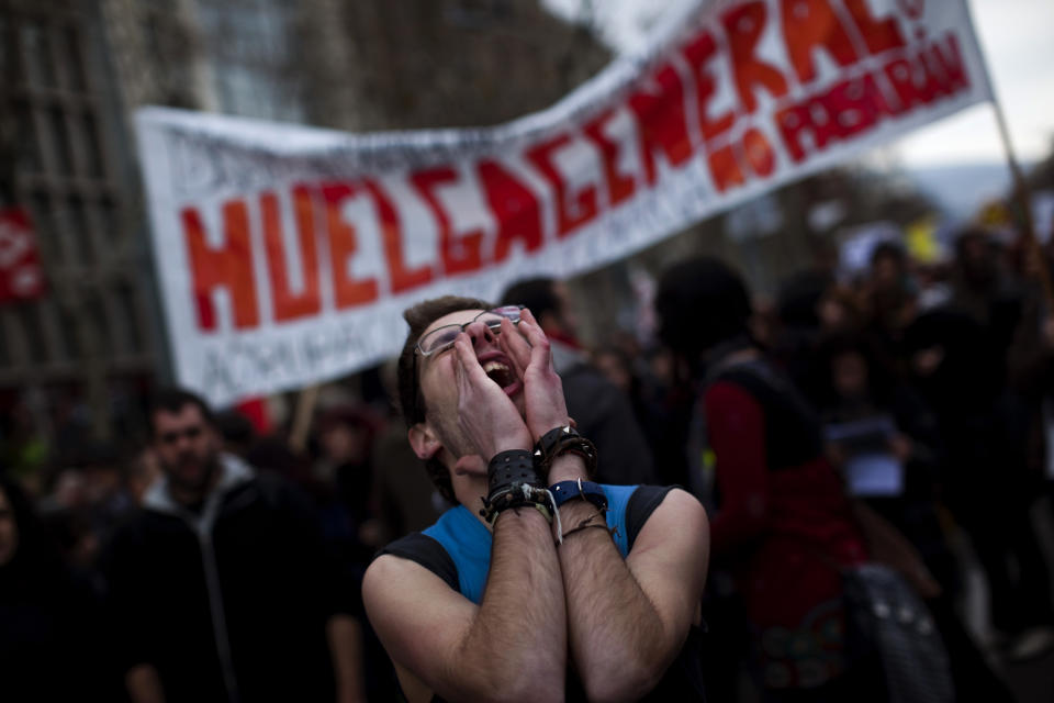 Sergi, 20, shouts slogans against the government's recently approved labor reforms during a demonstration in Barcelona, Spain, Friday Feb. 19, 2012. Marches organized by the country's main trade unions are taking place throughout Spain. (AP Photo/Emilio Morenatti)