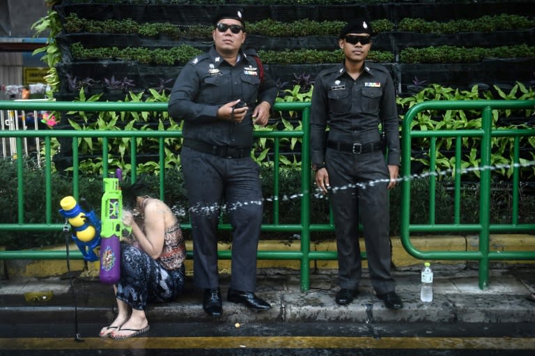 Thais and tourists drench each other with water pistols across the nation for the Songkran festival