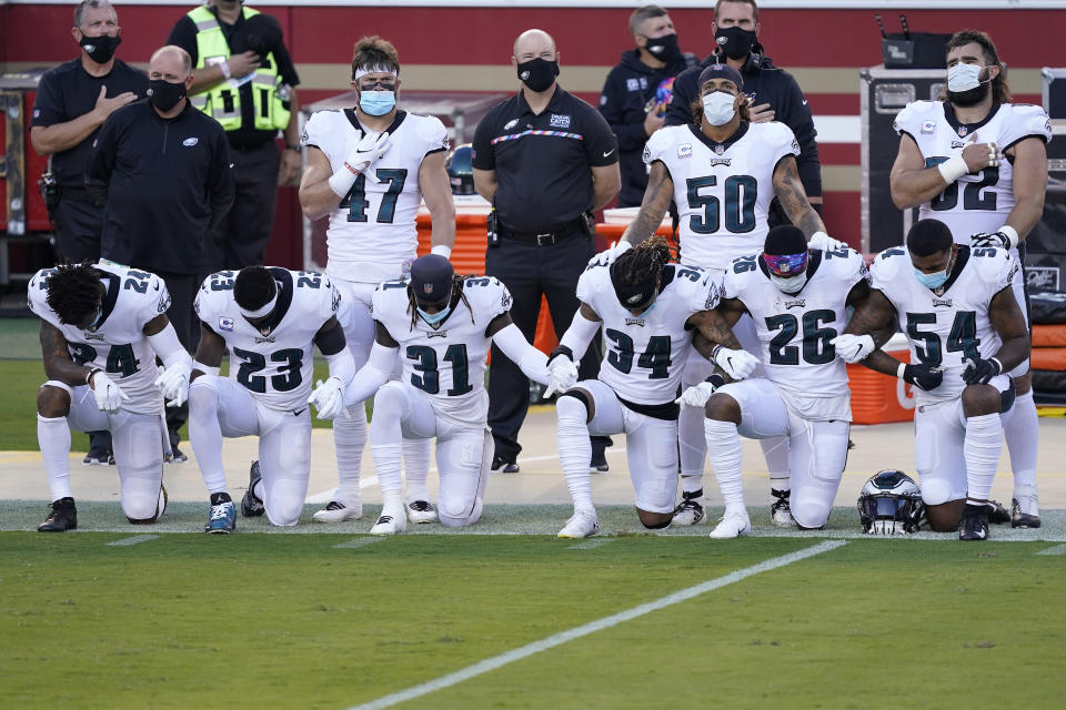 Philadelphia Eagles' Darius Slay, from bottom left, kneels with Rodney McLeod, Nickell Robey-Coleman, Cre'von LeBlanc, Miles Sanders and Shaun Bradley during the national anthem before an NFL football game in Santa Clara, Calif., Sunday, Oct. 4, 2020. (AP Photo/Tony Avelar)