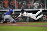 Houston Astros' Chas McCormick (20) is tagged out at home plate by Texas Rangers catcher Jose Trevino (23) during the 10th inning of a baseball game Thursday, May 13, 2021, in Houston. (AP Photo/David J. Phillip)