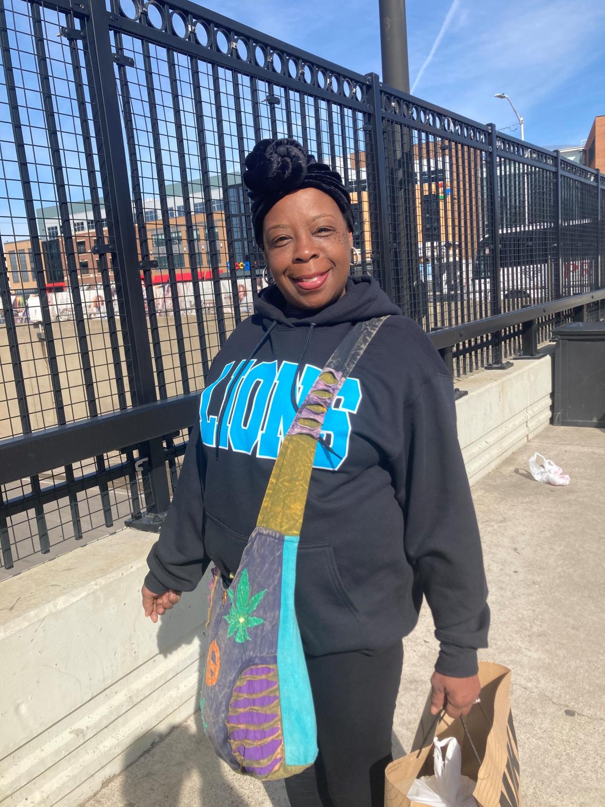 Chelsey Rayford, 56, of Detroit walks to work Thursday morning from the last southbound Qline stop, which outside of Little Caesars Arena for the NFL draft. Her stop is normally about 1 mile away.