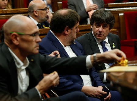 Catalan President Carles Puigdemont (R) attends a plenary session at the Catalan regional Parliament in Barcelona, Spain, October 27, 2017. REUTERS/Albert Gea