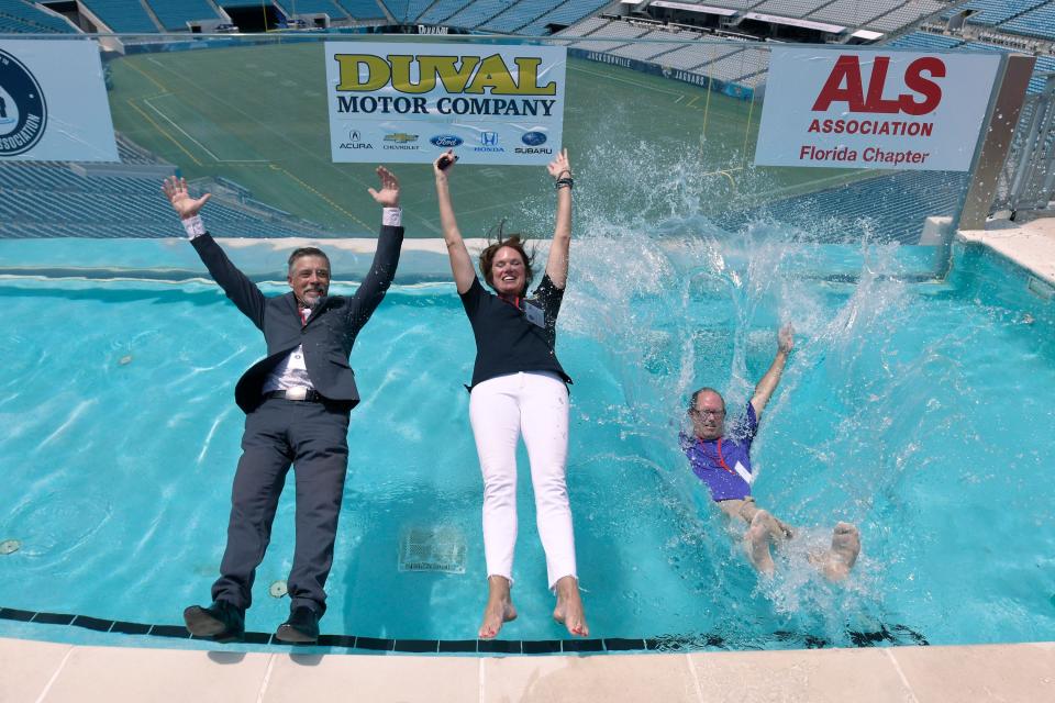 Dr. Bjorn Oskarsson of Mayo Clinic, State Attorney Melissa Nelson and Dr. Michael Pulley of UF Health are the first to take the plunge during Tuesday's ALS fundraising event at TIAA Bank Field.