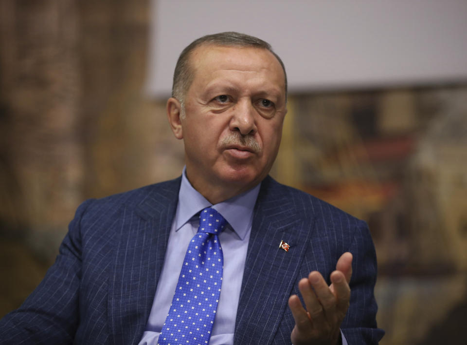 Turkey's President Recep Tayyip Erdogan speaks to Turkish journalists, in Istanbul, Sunday, Oct. 13, 2019. Erdogan has rejected offers for mediation with Syrian Kurdish fighters as the Turkish military continues its offensive against them in northern Syria. (Presidential Press Service via AP, Pool)