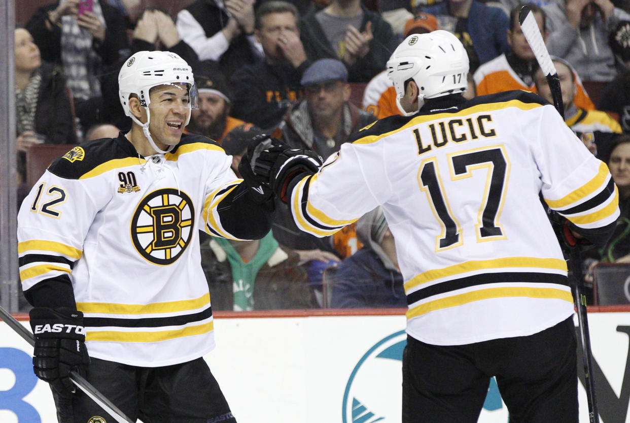 Boston Bruins' Jarome Iginla, left, celebrates his goal with Milan Lucic, right, during the first period of an NHL hockey game against the Philadelphia Flyers, Saturday, Jan. 25, 2014, in Philadelphia.  (AP Photo/Chris Szagola)