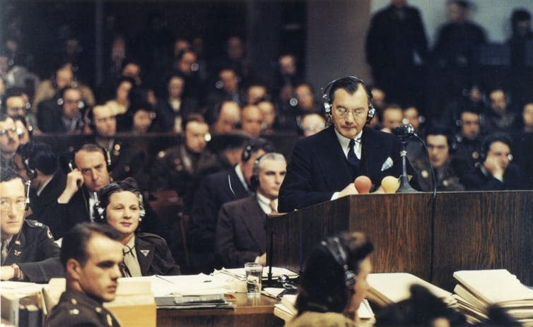 <span class="caption">Robert Jackson speaks at the Nuremberg trials in 1945.</span> <span class="attribution"><a class="link " href="https://en.wikipedia.org/wiki/Robert_H._Jackson#/media/File:Jackson_Nuremberg_color.jpg" rel="nofollow noopener" target="_blank" data-ylk="slk:Raymond D'Addario/Wikipedia;elm:context_link;itc:0;sec:content-canvas">Raymond D'Addario/Wikipedia</a></span>