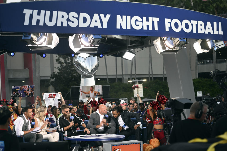 Members of the Thursday Night Football crew, from let, Tony Gonzalez, Charissa Thompson, Ryan Fitzpatrick, Andrew Whitworth, and Richard Sherman on air before an NFL football game between the Baltimore Ravens and Tampa Bay Buccaneers Thursday, Oct. 27, 2022, in Tampa, Fla. (AP Photo/Jason Behnken)