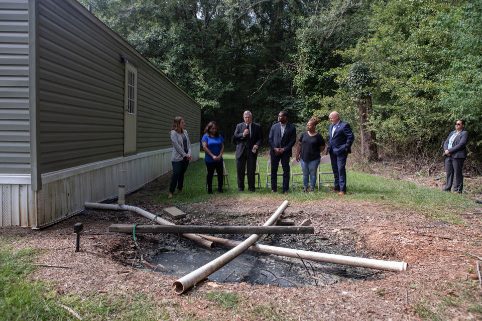 Regan meets the press at an open sewage pit in a backyard in Lowndes County, Alabama, on Aug. 22, 2022 <span class="copyright">Charity Rachelle for TIME</span>