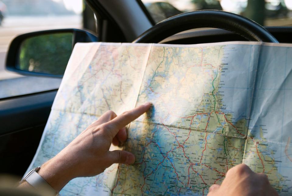 Person reading map in car