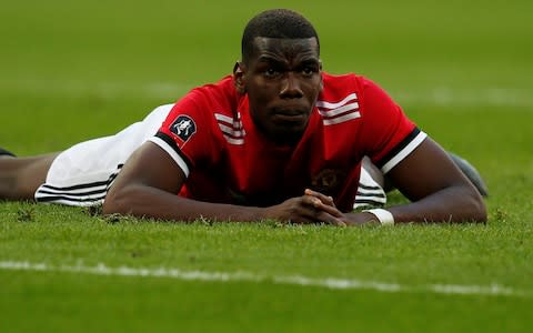 Paul Pogba lies on the Wembley turf - Credit: Reuters