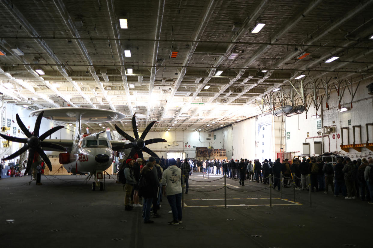 Crew members queue up in the hangar as they wait to disembark the U.S. Aircraft Carrier USS Gerald R. Ford while anchored in the Solent near Gosport, Britain, November 17, 2022. REUTERS/Henry Nicholls