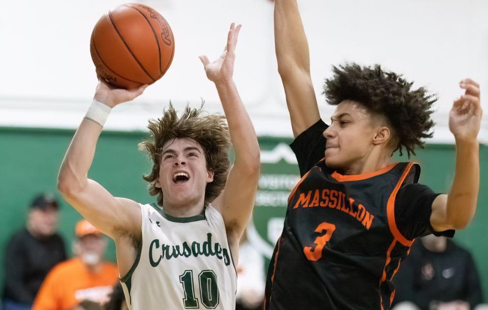 Central Catholic’s Gavin Layman shoots as Massillon’s Chris Knight defends during Friday's game.