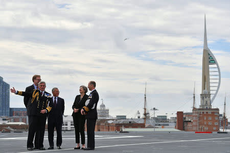 Britain's Prime Minister Theresa May talks with Commodore Jerry Kyd, Captain of the British aircraft carrier HMS Queen Elizabeth, during her tour of the ship, after it arrived at Portsmouth Naval base, its new home port, in Portsmouth, Britain August 16, 2017. REUTERS/Ben Stansall