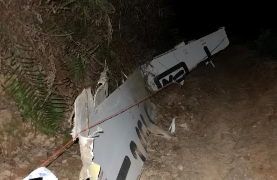 Plane debris is seen at the site of the crash. 