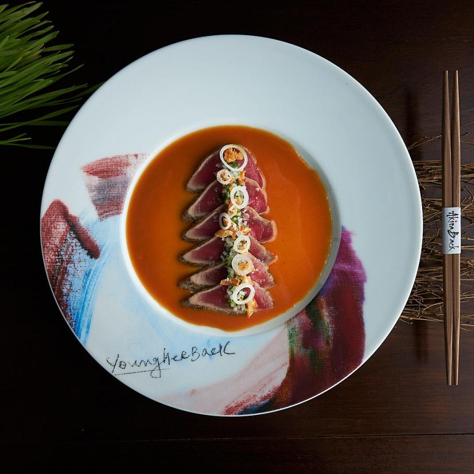 Chef Akira Back's tuna tataki dish is topped with a mustard sumiso sauce and pickled wasabi. The dish is photographed here on a plate designed by the chef's artist mother, Young Hee Back.