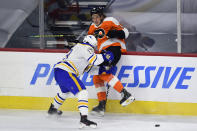 Philadelphia Flyers' Nolan Patrick, right, is checked into the boards by Buffalo Sabres' Tobias Rieder during the first period of an NHL hockey game, Monday, Jan. 18, 2021, in Philadelphia. (AP Photo/Derik Hamilton)