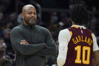 Cleveland Cavaliers head coach J.B Bickerstaff, left, talks with Darius Garland in the first half of an NBA basketball game against the Utah Jazz, Sunday, Dec. 5, 2021, in Cleveland. (AP Photo/Tony Dejak)