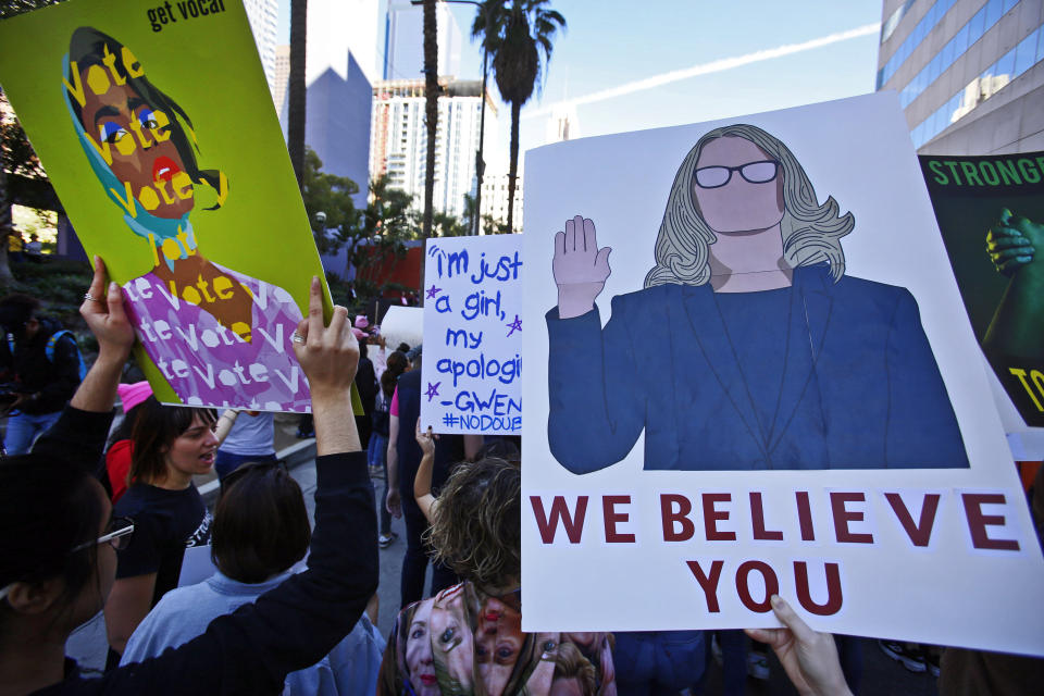 Demonstrators hold signs as they gather at Pershing Square during the Women’s March in Los Angeles on Saturday, Jan. 19, 2019. (Photo: Damian Dovarganes/AP)