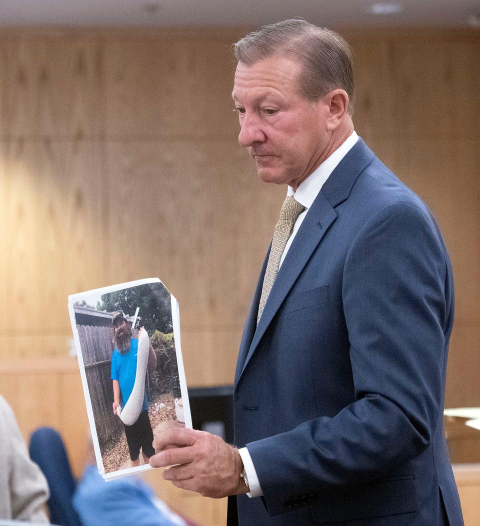 Attorney G. Jeffery Vernis shows the opposing counsel a photo of Travis Gill during day two of testimony against Skanska on Wednesday, Nov. 8, 2023. Gill is suing Skanska for damages to his oyster farming operation during Hurricane Sally.